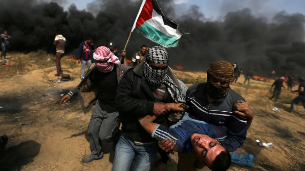 Wounded demonstrator is evacuated at a protest at the Israel-Gaza border in the southern Gaza Strip. REUTERS/Ibraheem Abu Mustafa