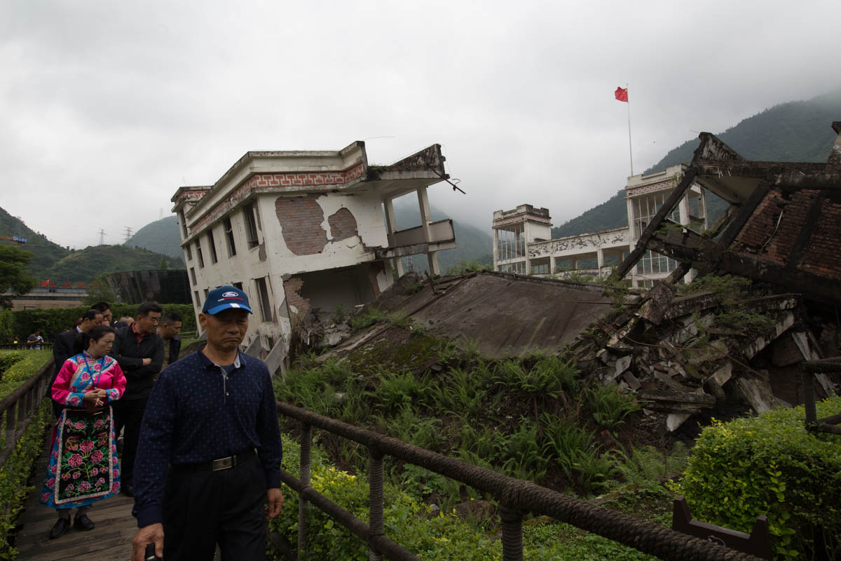 On the photo taken on May 10,2018, visitors walked by the debris of collapsed school buildings. The destroyed school buildings and death of students remain a source of national heartbreak for the Chin