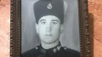 A photo of Leila's late father hangs in the living room [Al Jazeera]