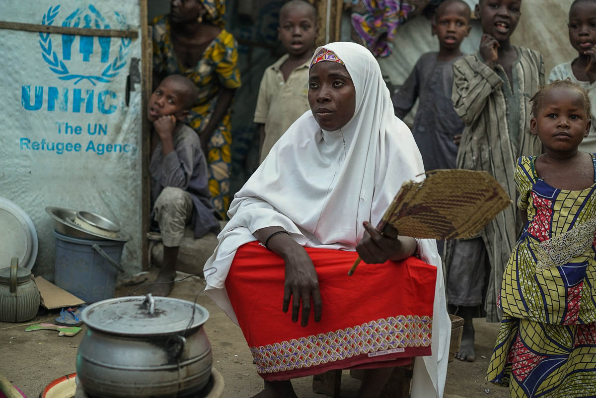 Falimatu, age 40, is cooking dinner for her 5 children in Kawar Maila Camp, an informal camp in Maiduguri built by a local Nigerian to house and shelter IDPs fleeing from the Boko Haram insurgency.