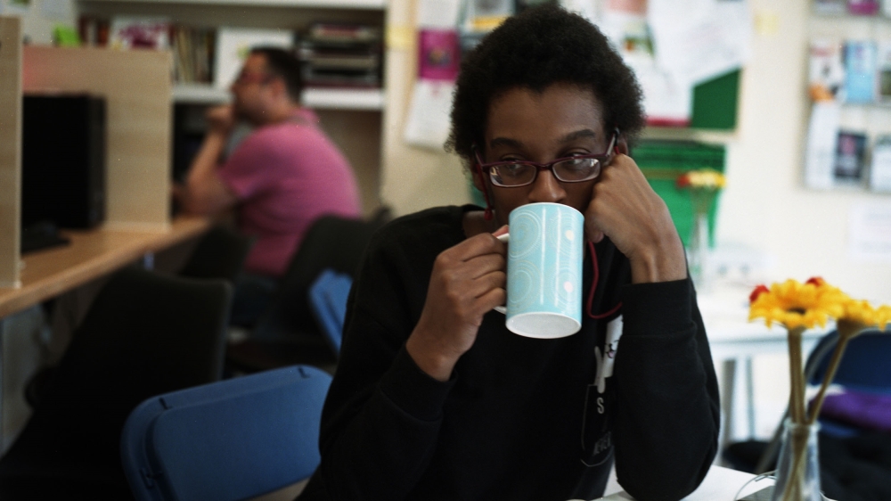 *Anna, a regular food-bank user, takes a break from job applications [James Rippingale/Al Jazeera]