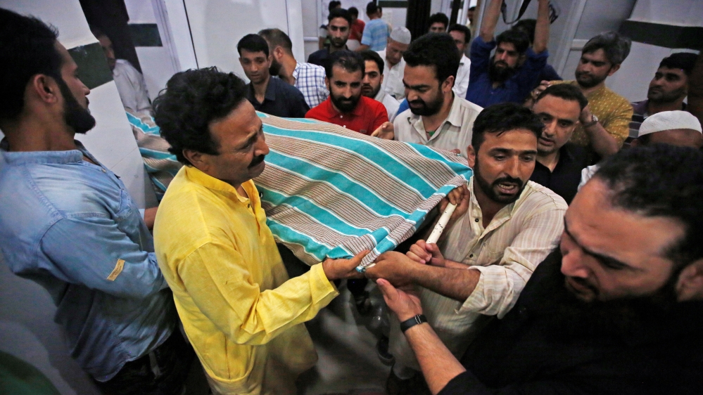 People carry the body of Syed Shujaat Bukhari, the editor of Rising Kashmir daily newspaper, who was killed by unidentified gunmen outside his office in Srinagar