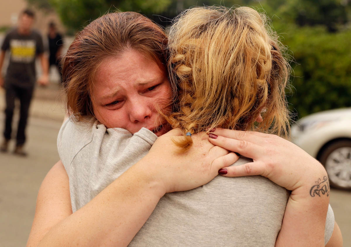 Carla Bledsoe, facing camera, hugs her sister Sherry outside of the sheriff''s office after hearing news that Sherri''s children James, 4, and Emily 5, and grandmother were killed in a wildfire Saturday