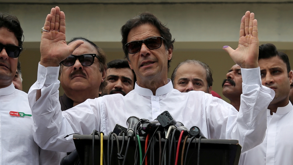 Imran Khan speaks to members of media after casting his vote at a polling station during the general election in Islamabad