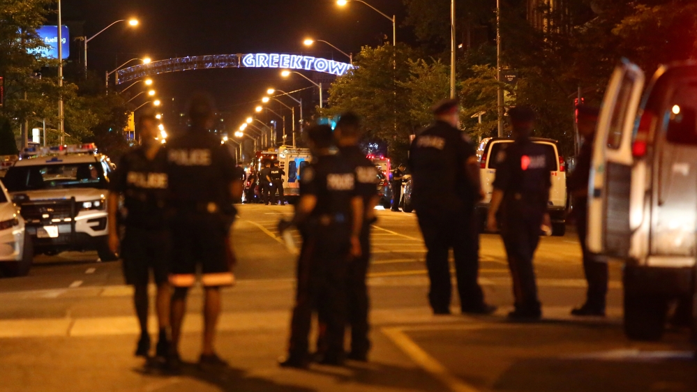 Police are seen near the scene of a mass shooting in Toronto, Canada [Chris Helgren/Reuters]