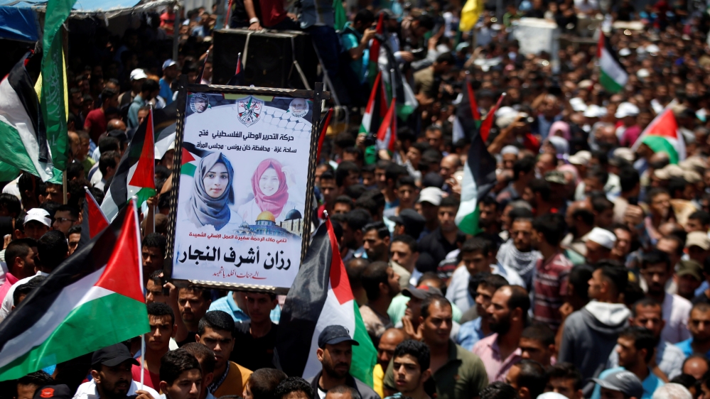 Mourners attend the funeral of Palestinian nurse Razan Al-Najar, who according to health officials and a witness was killed by Israeli forces as she tried to help a wounded protester in Gaza