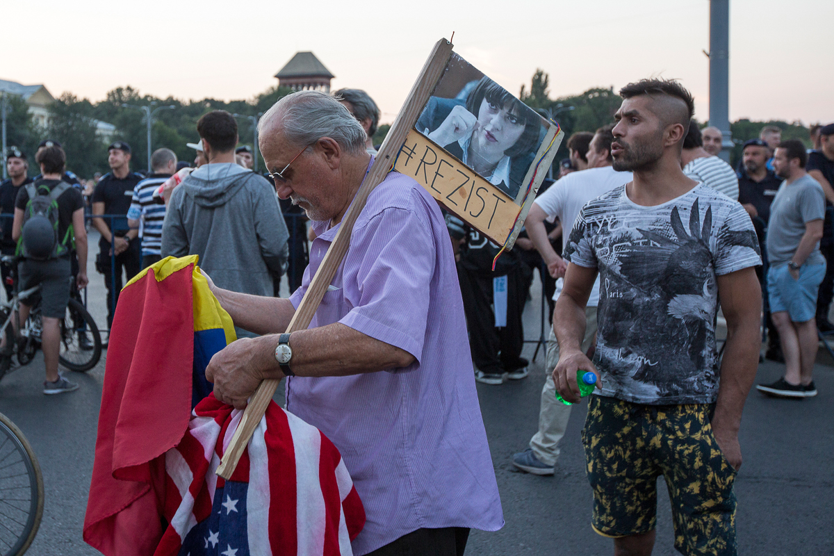 5. A protester holds a photo of Laura Codruta Kovesi, with the hashtag “resist”. Kovesi, the former chief prosecutor of the DNA, was revoked on Monday by President Klaus Iohannis following a decision
