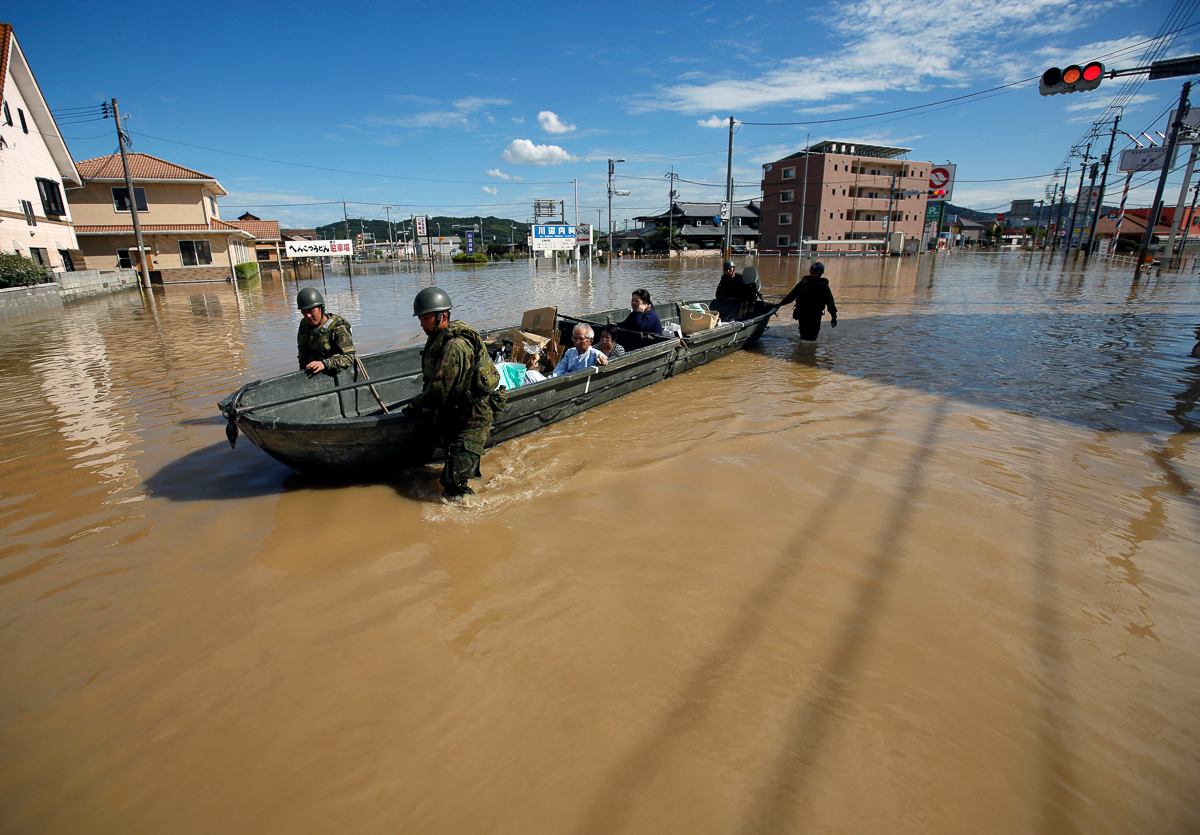 Japan Self-Defense Force soldiers rescue people from a flooded area in Mabi town in Kurashiki, Okayama Prefecture, Japan, July 8, 2018. REUTERS/Issei Kato