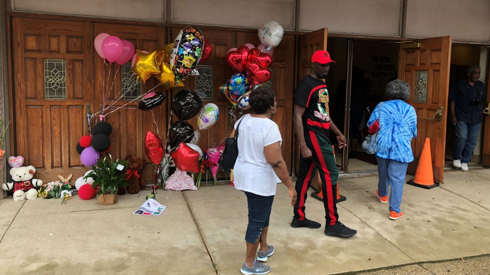 Many left balloons and flowers outside Detroit's New Bethel Baptist Church [Tom Szypulski/Al Jazeera] 