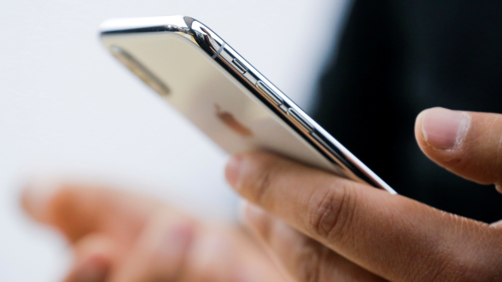 FILE PHOTO: An attendee uses a new iPhone X during a presentation for the media in Beijing