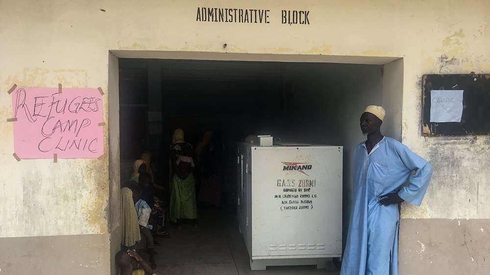 A displaced man stands outside the makeshift clinic in the camp at Zurmi in Zamfara state [Eromo Egbejule/Al Jazeera]