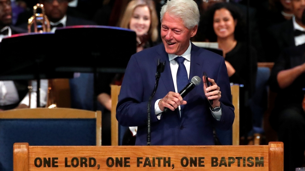 Clinton plays Franklin's song on his phone while speaking at the funeral [Mike Segar/Reuters]