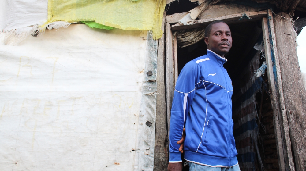 Mohammed Salie stands in front of a new structure, his third home on the island [Mara Karas-Nelson/Al Jazeera]
