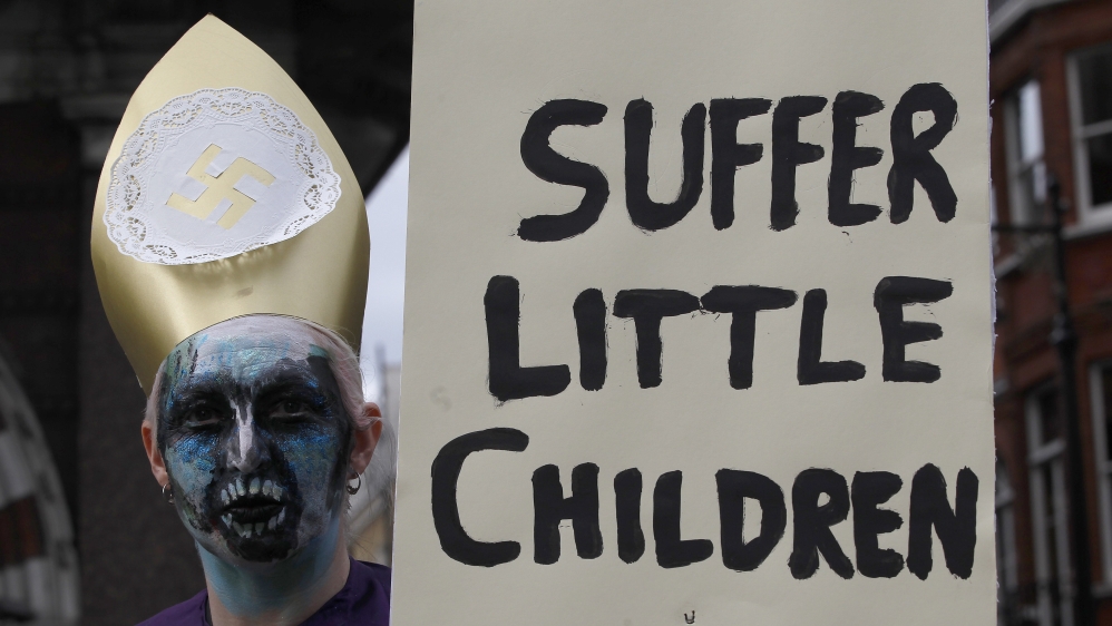 A demonstrator holds a banner during a protest against the visit of Pope Benedict XVI in London on September 18, 2010 [Stefan Wermuth/Reuters]