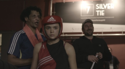Salma, trainer Mohammed Idrissi and her father, trainer Hamid Ben Abdesselam, during Salma's big fight. [Screenshot/Al Jazeera]