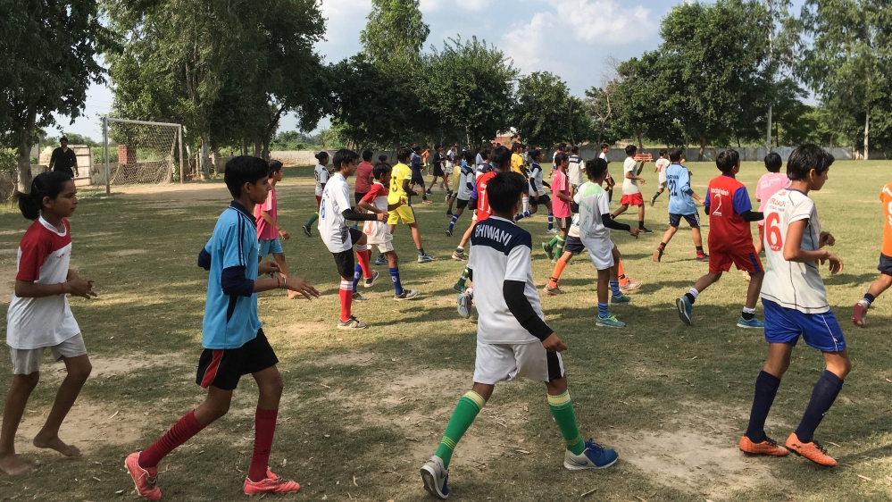 Girls and boys train together in Alakhpura [Adnan Bhat/Al Jazeera]