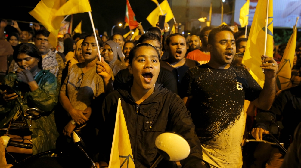 Supporters of Maldives' opposition candidate Ibrahim Mohamed Solih celebrate early on Monday [Eranga Jayawardena/ AP Photo]