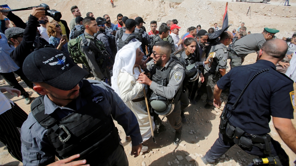 Palestinian man scuffles with Israeli troops as they protest against Israel''s plan to demolish the Palestinian Bedouin village of Khan al-Ahmar, in the occupied West Bank