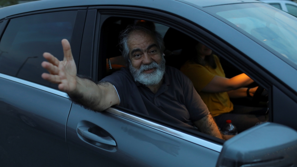 Journalist Mehmet Altan waves to media after being released from the prison in Silivri, near Istanbul
