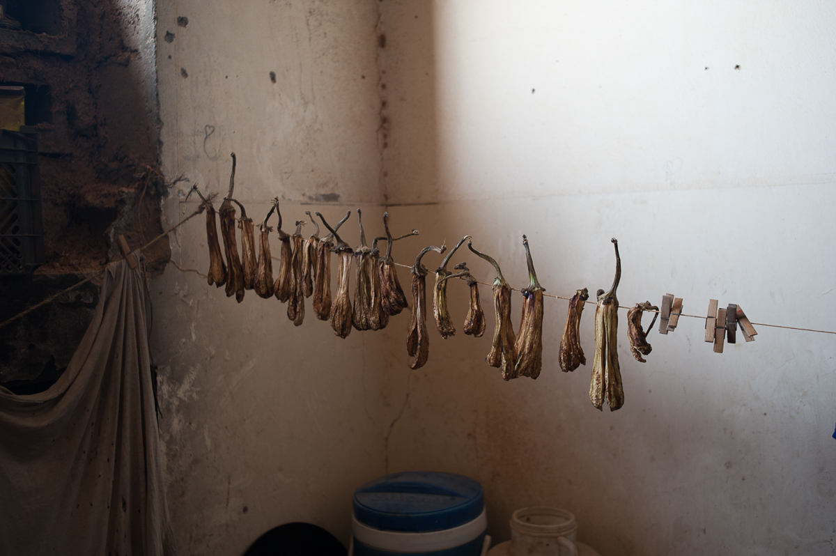 Dry aubergines for the winter. Food is often donated to the IDPs of Harijieh by the soldiers of a nearby military base. September 2018