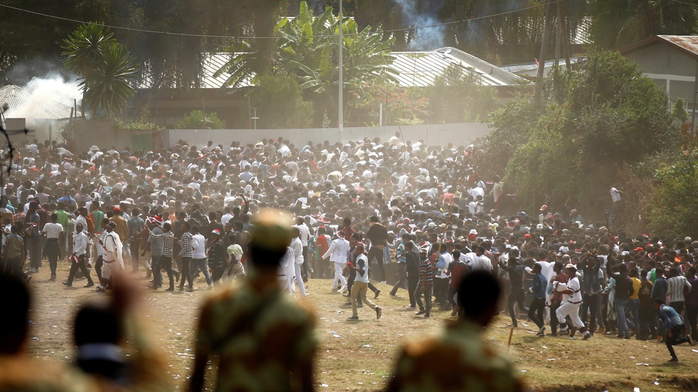 Protestors run from tear gas launched by security personnel during the Irecha, the thanks giving festival of the Oromo people in Bishoftu town of Oromia region, Ethiopia, October 2, 2016 [Tiksa Negeri/Reuters]