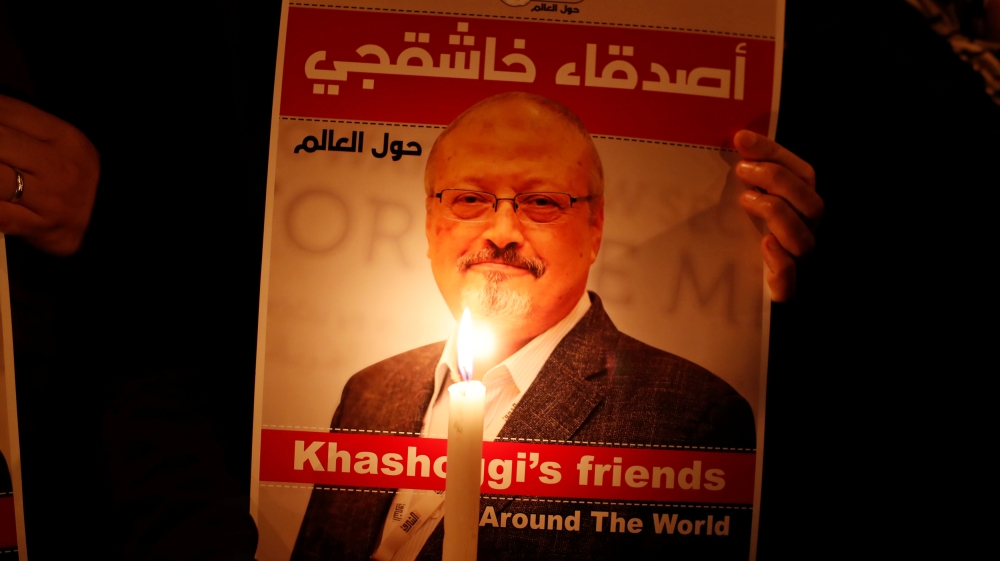 A demonstrator holds a poster with a picture of Saudi journalist Jamal Khashoggi outside the Saudi Arabia consulate in Istanbul
