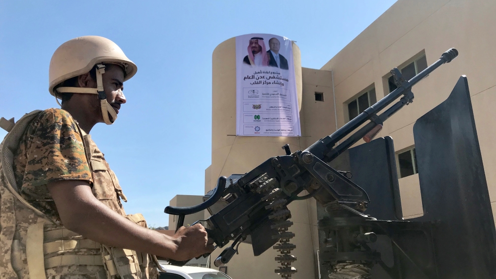 A soldier mans a machine gun on a patrol truck outside a hospital renovated by Saudi Arabia in Aden