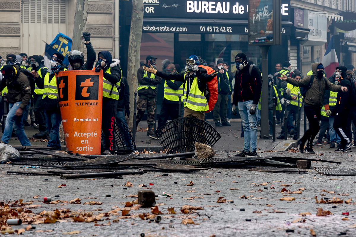 Protesters start to set up a barricade using items found on the streets during a demonstration near the Champs ElysE`es called for by the i`Gilets Jaunesi^ movement on December 01, 2018 in Paris, Fran