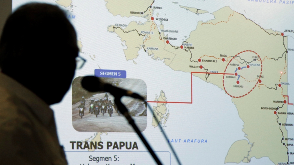 Indonesia''s Minister of Public Works and Public Housing Basuki Hadimuljono shows a Trans Papua map during a news conference in Jakarta