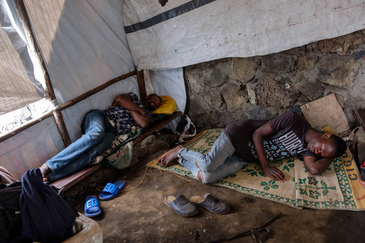 Baba (20) has been living on the streets for four years now. He shares his makeshift hut on the waterfront with a few older guys. He practices his raps at night, in front of the tent. He believes tha