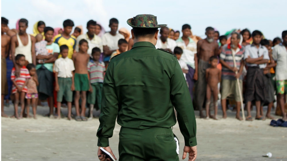 Muslim-majority Rohingya wait in a temporary camp outside Maungdaw in Myanmar's northern Rakhine state to cross the border to Bangladesh in November 2017 [Wa Lone/Reuters]