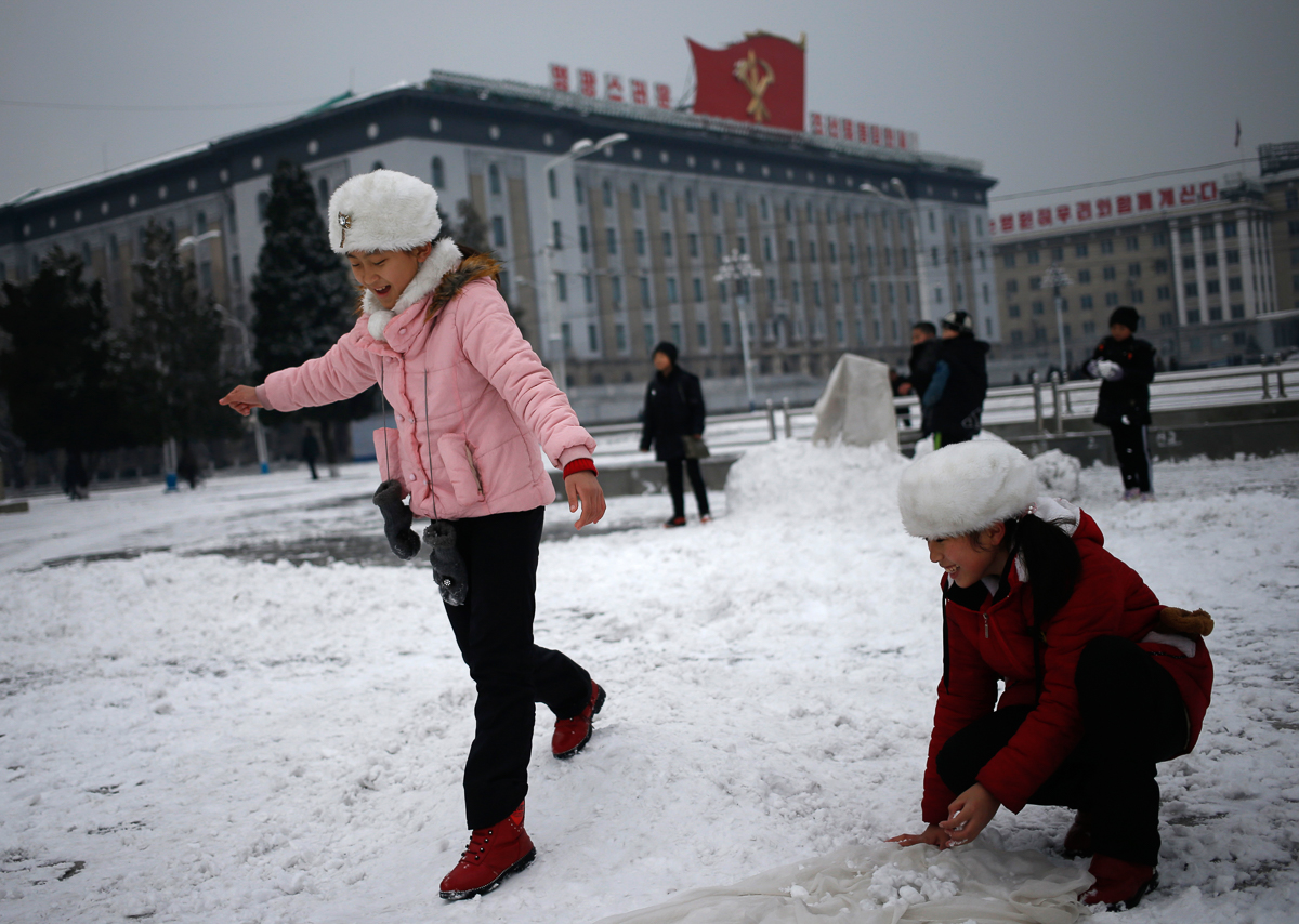 North Korean girls play with the snow on Kim Il Sung Square in Pyongyang, North Korea, where the winter season has started, on Sunday, Dec. 16, 2018. (AP Photo/Dita Alangkara)
