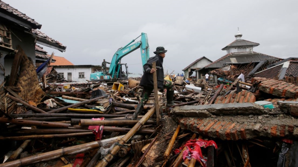 A soldier searches for the tsunami victims in Sumur [Achmad Ibrahim/Associated Press]