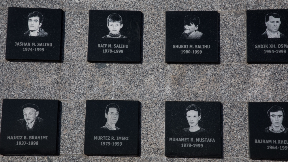 The memorial wall at Racak displays the names and photos of those killed in the village 20 years ago [Valerie Plesch/Al Jazeera]