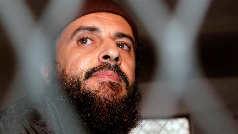 FILE PHOTO: Yemeni Islamic militant Jamal al-Badawi looks from behind bars during the first hearing of a Sana''a court of appeals hearing