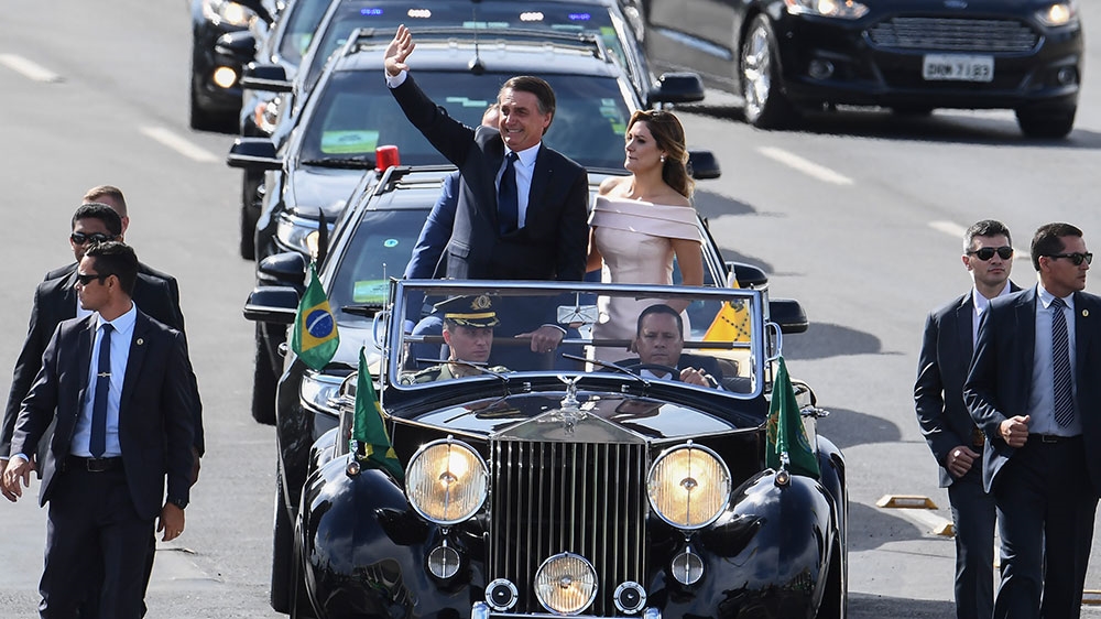The presidential convoy, led by Brazil's new President Jair Bolsonaro and his wife Michelle Bolsonaro, heads towards Planalto Palace to receive the Presidential sash during Bolsonaro's inauguration ceremony [Evaristo SA/AFP]