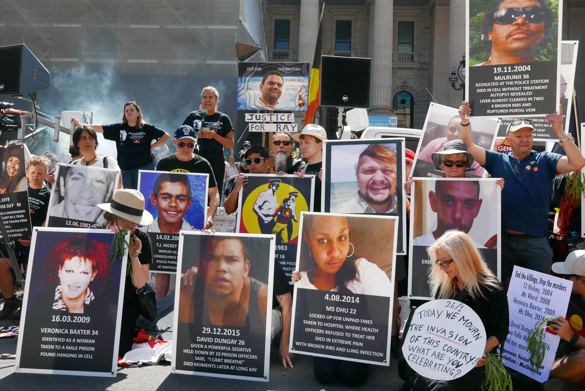 Aboriginal deaths in custody or at the hands of the police is an ongoing issue in Australia. Here, protestors hold placards showing the faces of Aboriginal killed in such circumstances.
