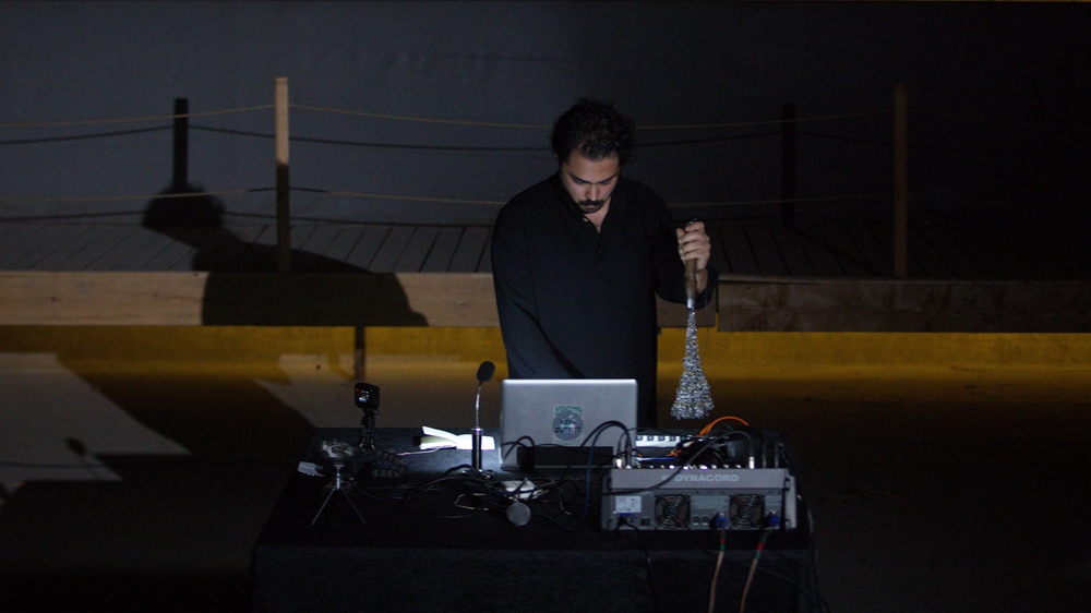The musician uses Zanjeer, a chain used during Shia religious rites, as a musical instrument [Erfan Dadkhah/Al Jazeera]