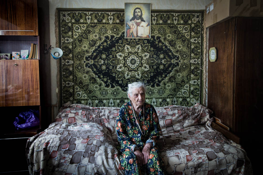 Irina Vyschnyak's 15square-metre room has become a self-contained apartment which combines a living room, bedroom and kitchen. [Erik Messori/CAPTA/Al Jazeera]