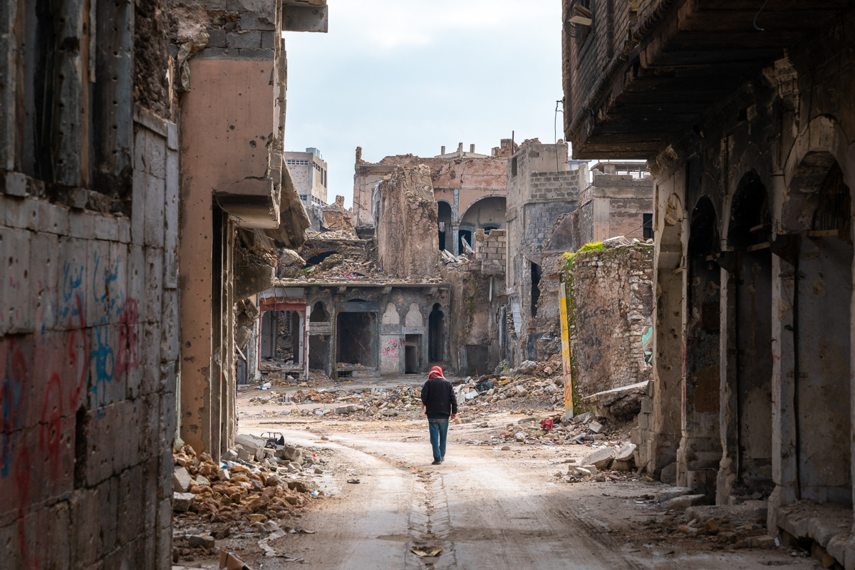 A Mosulite walks through one of he Old City''s deserted streets.