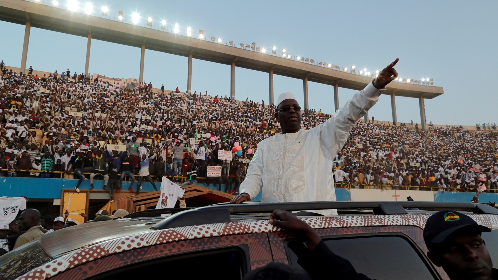 Senegal''s President and candidate for the upcoming presidential elections Macky Sall greets his supporters as he arrives to attend his final campaign rally in Dakar