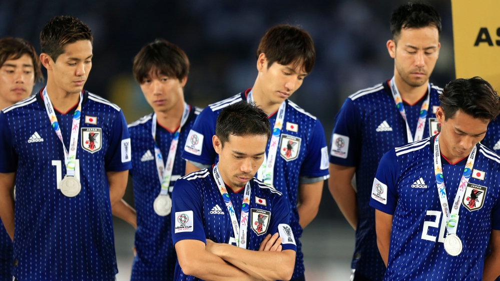 Japan's players look dejected after losing the Asian Cup final [Thaier Al-Sudani/Reuters]