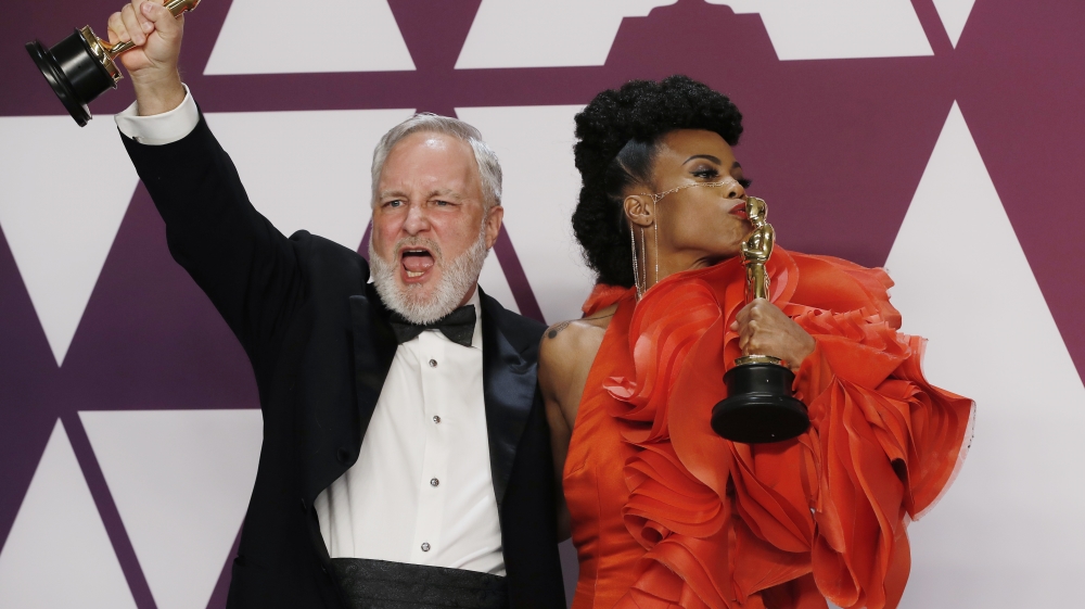 Hannah Beachler and Jay Hart celebrate backstage with their Best Production Design awards for 'Black Panther' [Mike Segar/Reuters]