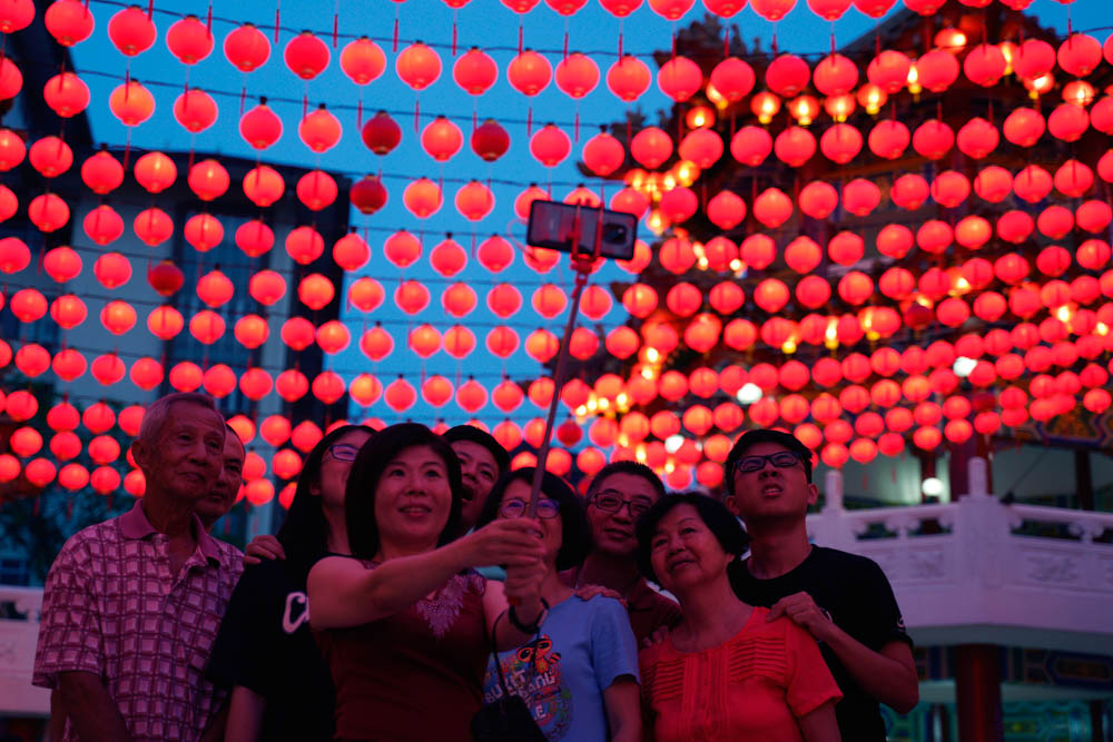 Malaysia ethnic Chinese take a selfie by a temple in Kuala Lumpur, Malaysia, Monday, Feb. 4, 2019. Chinese around the world will be celebrating the start of the Year of Pig on Feb. 5 this year in the