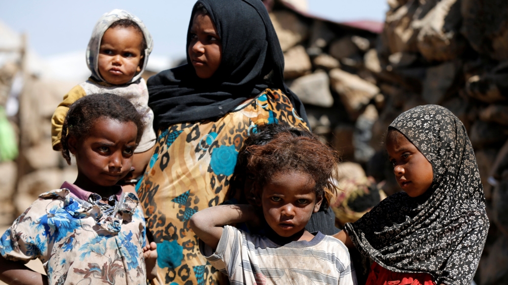Children stand at a makeshift camp for internally displaced people near Sanaa, Yemen