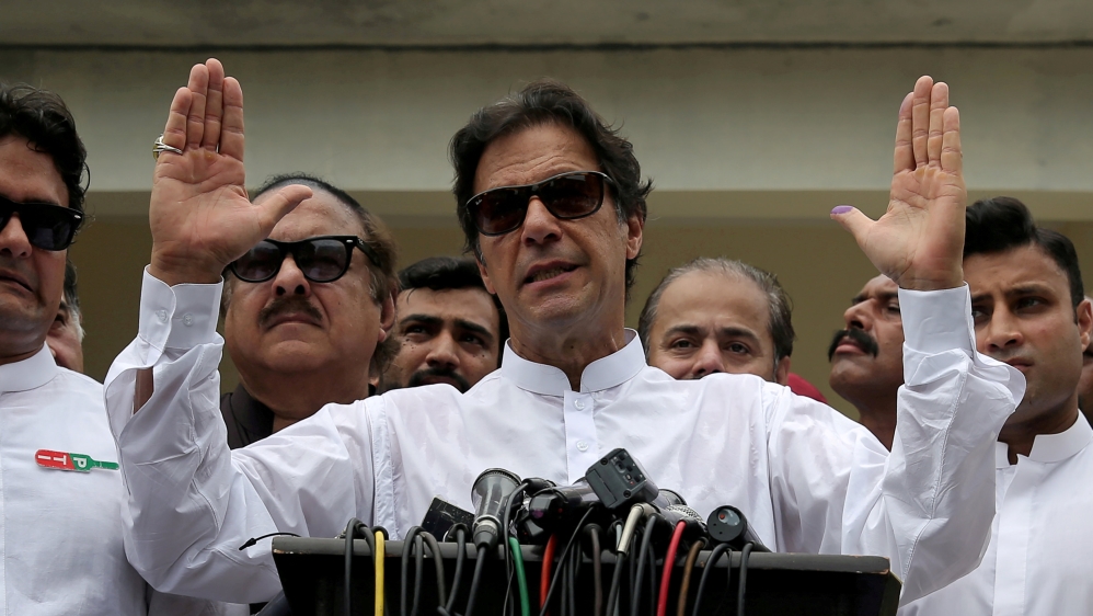 FILE PHOTO: Cricket star-turned-politician Imran Khan, chairman of Pakistan Tehreek-e-Insaf (PTI), speaks after voting in the general election in Islamabad