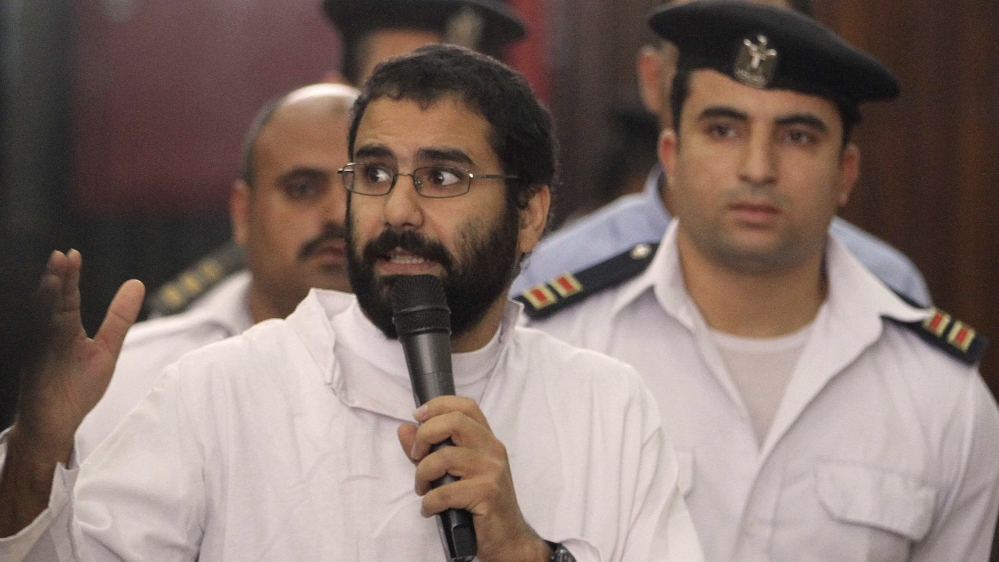 Activist Alaa Abdel Fattah speaks in front of a judge at a court during his trial in Cairo
