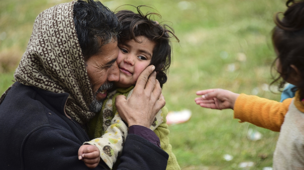 A father who fled his hometown in Chakoti hugs his crying daughter. The family has taken shelter in a school at Hatian Bala, 40 kilometres from Muzaffarabad, capital of Pakistani Kashmir [M D Mughal/AP]