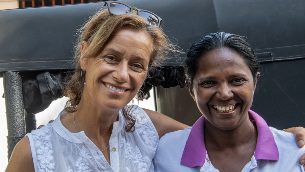 Mary, left, pictured with tuk-tuk rider Jega [Smriti Daniel/Al Jazeera]