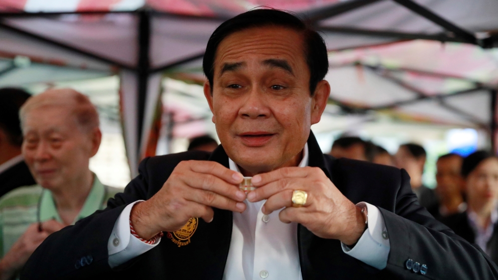 Thailand''s Prime Minister Prayut Chan-o-cha drinks tea with people who are exercising in Lumphini Park in Bangkok